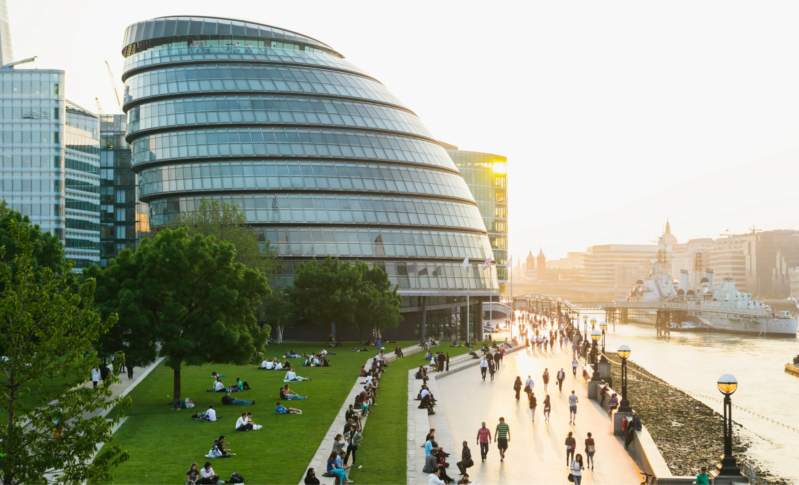 building with people walking by the Thames